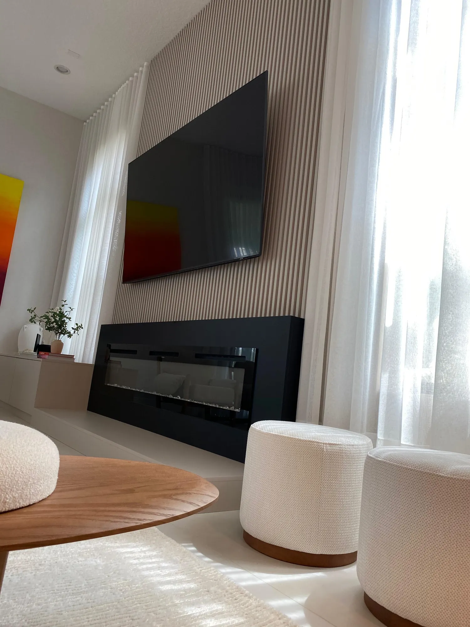 Slatted media wall with fireplace built by Domu